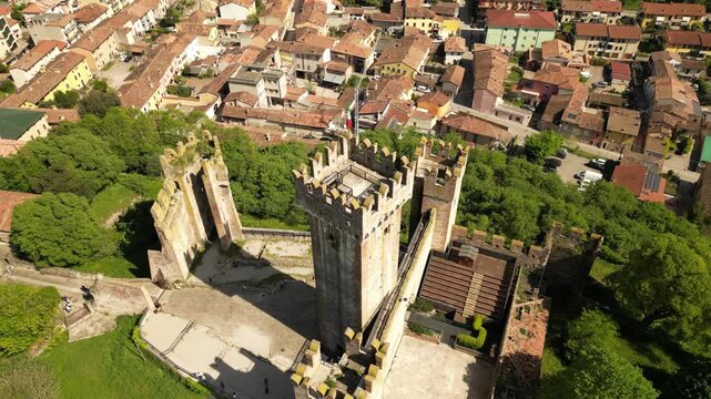 Castle Fortress and Cityscape: A majestic ancient castle, its weathered stone walls and towering turrets standing proudly overlooking a sprawling cityscape.