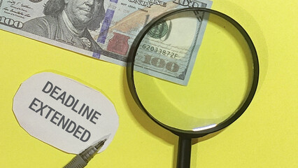 Deadline Extended Examining Finances Through a Magnifying Glass on Yellow Background