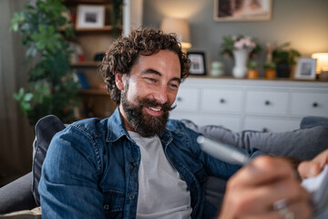 Fototapeta premium Man smiling enjoying creative writing activity at home