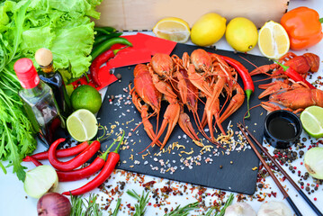 boiled crayfish large on black slate on a table with food decor