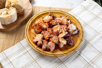 Pulpo a la gallega serving with paprika and bread