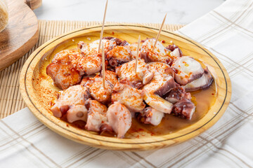 Galician octopus tapa serving on wooden plate