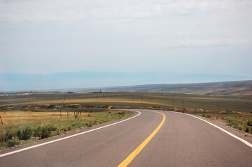 A winding road stretching through a vast open landscape