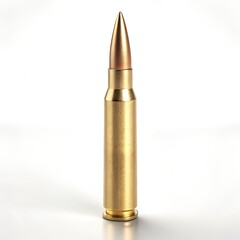 Single golden bullet standing upright on a white surface with soft studio lighting