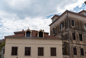 Building with terracotta roof and shutters