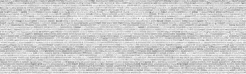 White washed shabby brick wall wide panoramic texture. Light gray rough whitewashed brickwork...