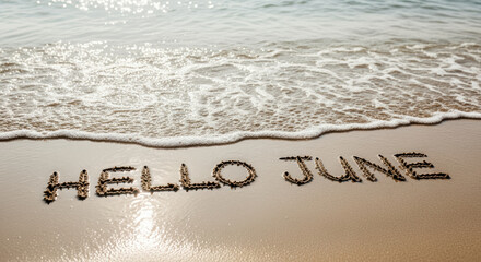 hello june written on sandy beach with gentle ocean waves, symbolizing summer, new beginnings, and coastal relaxation