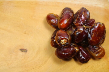 Sweet dried dates placed on a wooden board