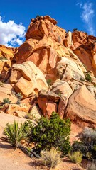 Dramatic perspective on a sunlit sandstone formation against a blue sky
