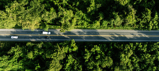 Forest road ,Top view of road in the middle of the forest curve construction up to mountain, panoramic view of Rainforest ecosystem elevated road that surrounds natural forest.	