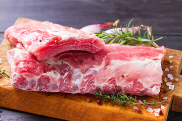 Raw pork ribs with herbs prepared for cooking. Rack of pork ribs