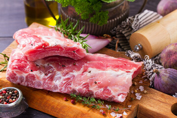Raw pork ribs with herbs prepared for cooking. Rack of pork ribs