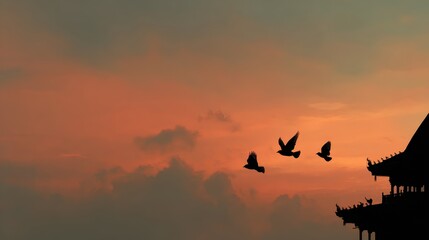 Sunset Over A Tiered Temple Roof With Flying Birds Silhouetted In