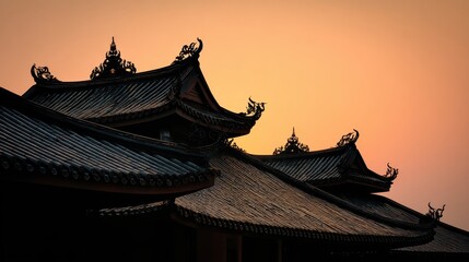 Sunset Silhouette of Traditional East Asian Temple Rooftops at Dusk