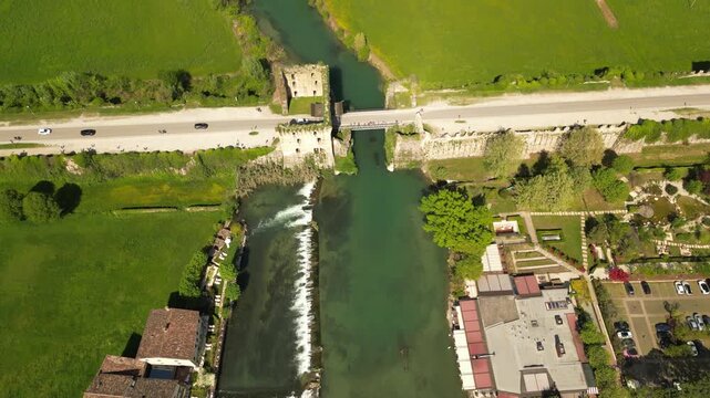 Scenic River and Bridge: A picturesque aerial perspective captures a serene river winding its way through a vibrant landscape, a sturdy bridge gracefully spanning its course.