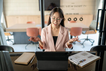 Asian businesswoman having video conference on tablet in meeting room