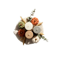 A flat lay of decorative pumpkins and candles arranged on a woven plate. The scene features autumn colors and natural elements, ideal for seasonal decor.