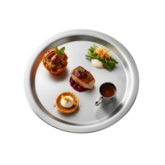 A silver serving tray holds a variety of gourmet dishes. There are a meat dish with sauce, a dessert tart, and a vegetable side, all presented elegantly.