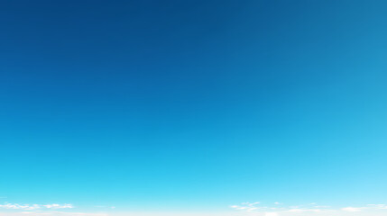 Fototapeta premium Vibrant Blue Sky with Wisps of Clouds - A Breathtaking Display of Nature's Beauty