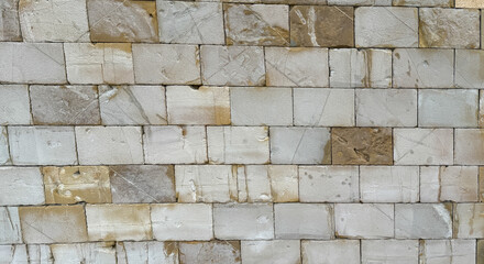 Detailed texture of an old sandstone wall with weathered rectangular stone blocks