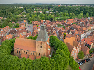 View of Mölln the Eulenspiegel town with medieval brick St. Nicolai church surrounded by trees and...