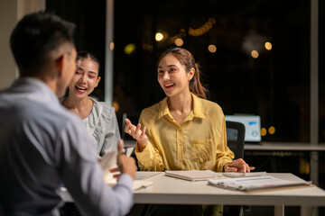 Business colleagues collaborating during successful late night office meeting