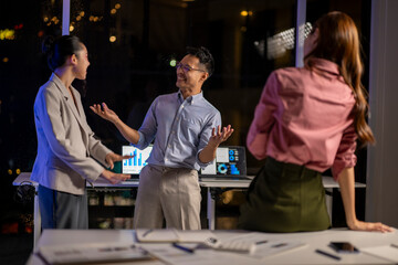 Colleagues collaborating discussing business data at night office