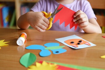 Creative Crafting with Colorful Paper: A Child Engaged in Fun Scissors Activity