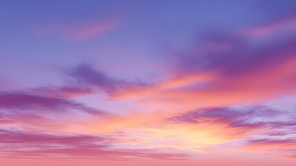 Naklejka premium A stunning sunset sky with vibrant colors and soft clouds. The sky is a beautiful canvas of pink, purple, and orange