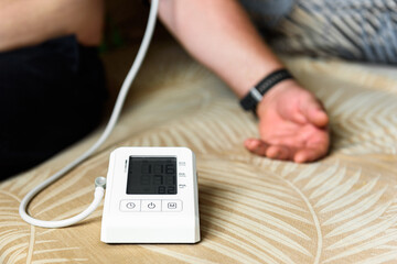 Measuring blood pressure with an automatic blood pressure monitor at home.
