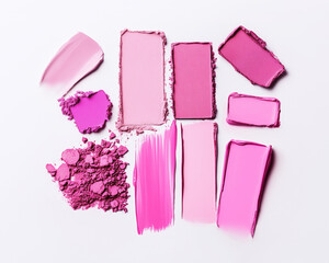 Group of pink magenta cosmetics swatches on white background. Horizontal close-up of eyeshadow texture, bright colors. Professional studio light, top view