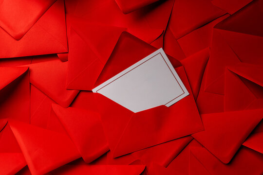 Stack of red envelopes with one open and card inside