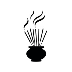 Incense sticks burning in a pot with smoke rising.