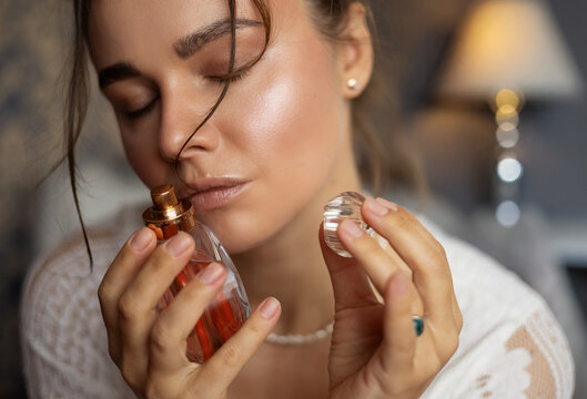 Beautiful woman and a bottle of perfume