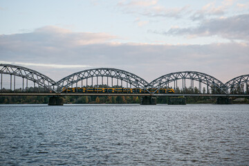 metal bridge over river with a train 