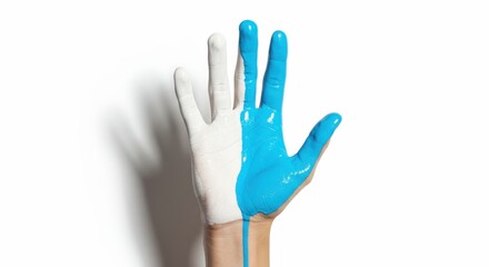Human hand painted half white and half bright blue symbolizing contrast and duality on a stark white background