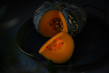 Ripe cut pumpkin still life on a tray. Thanksgiving Still Life. Holiday festival concept.