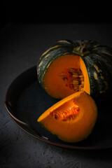 Autumn ripe cut green pumpkin still life on a tray. Thanksgiving Still Life. Holiday festival concept. Vertical orientation.