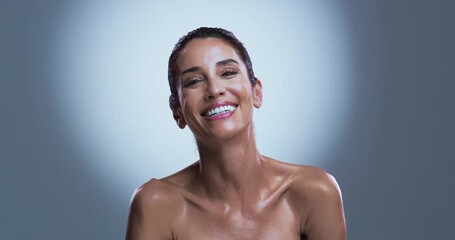 Face, beauty and woman in studio with smile for wellness, skincare or anti aging transformation. Mature, happy or female person with spotlight for smooth skin, dermatology or pride on gray background