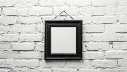 Ornate black picture frame hanging on a white brick wall, isolated on white background