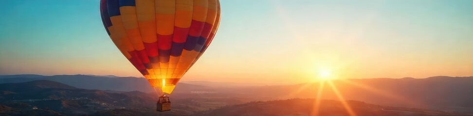 Obraz premium A vibrant hot air balloon ascends, bathed in the warm glow of sunrise, against a clear blue sky The basket is visible, and the landscape below is peaceful and expansive , peaceful, morning