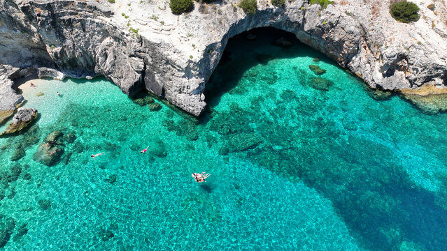 Aerial drone photo of tropical Caribbean island fjord shaped paradise bay with white rock arch caves and turquoise clear sea