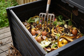 Organic Compost Bin Overflowing with Kitchen Scraps, Nutrient-Rich Soil for Sustainable Gardening Practices and Eco-Friendly Waste Management
