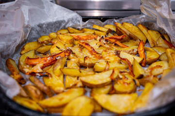 Roasted Potato Pieces with Cheese and Carrots on Baking Tray