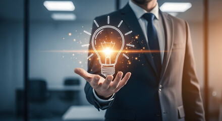 Businessman Holding a Glowing Lightbulb, Symbolizing Innovation and New Ideas
