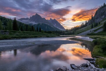 Dramatic sunset paints the sky with fiery oranges and purples reflecting in a serene mountain river surrounded by lush green forests and rugged peaks
