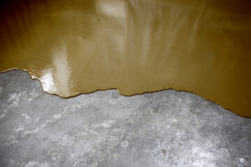 The concrete floor is dark ocher painted. Contractor will paint garage floor to accelerate home sale