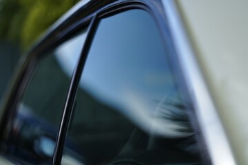 Close-Up View of a Car Window and Reflection Highlighting Modern Automotive Design and Glass Finish