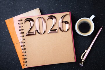 New year goals 2026 on desk. 2026 resolutions list with notebook on black table. Resolutions, plan, goals, action, checklist, idea concept. New Year 2026 resolutions, copy space
