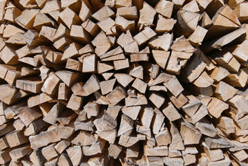 Stacked firewood logs. Chopped wood, a natural fuel for heating.  Woodpile texture, timber background.